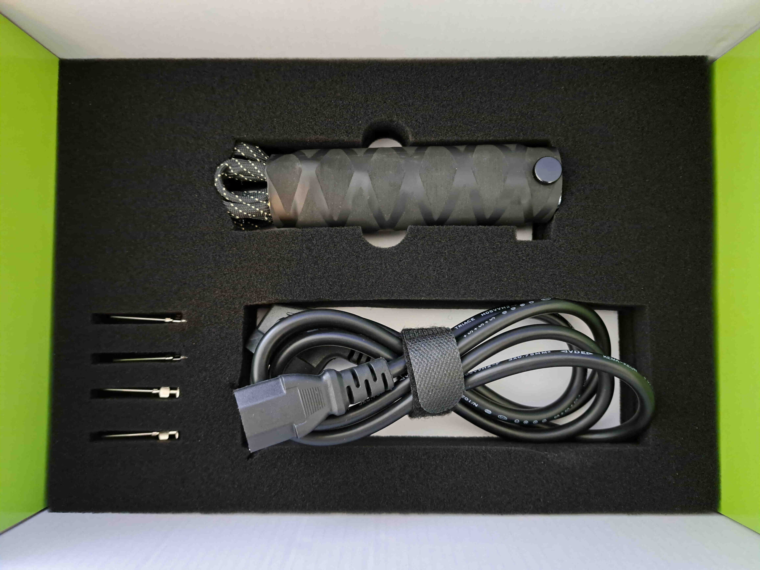 A black Cart Filling Gun with a cord.