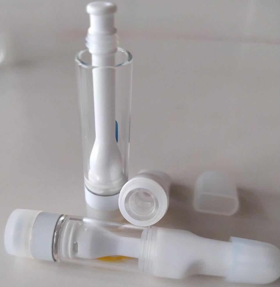 A white plastic bottle with a white lid and a Full Ceramic 1ml.