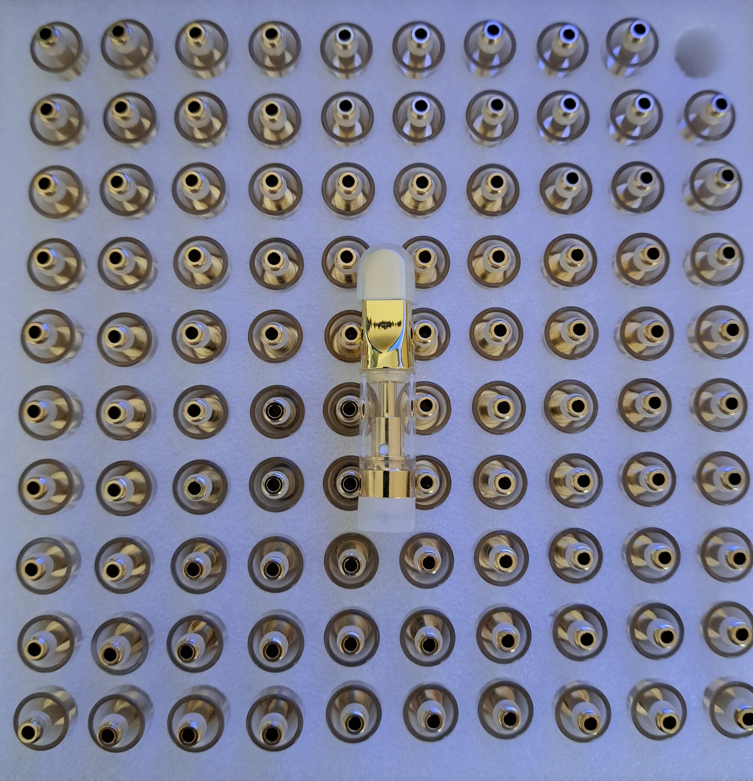 A plate adorned with numerous Gold - 0.5ml pins.