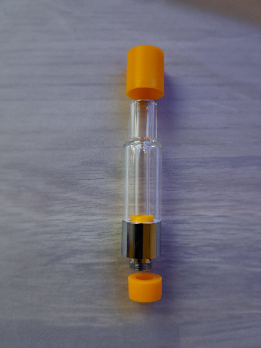 A VG02 - 1ml - Full Glass vape cartridge with a clear glass bottle and an orange lid.