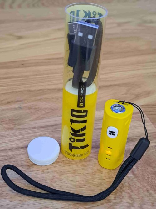 A yellow TIK10 Battery bottle with a yellow cord next to it.