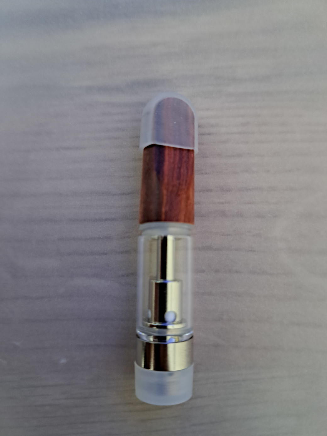 A V4 - Wood Tip - 0.5ml bottle with a wooden lid.