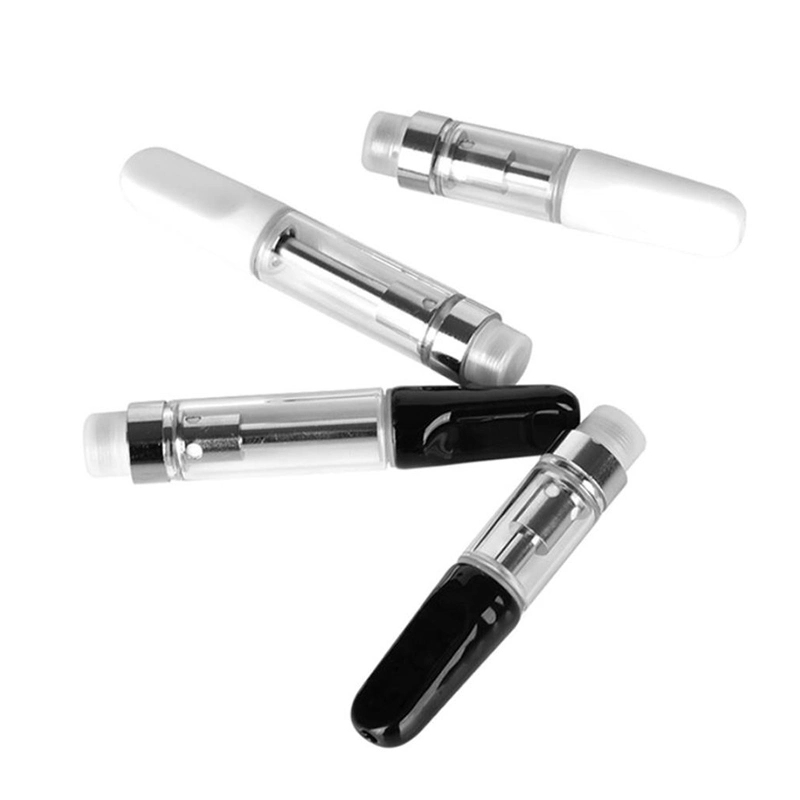 A group of black and white vape cartridges on a white surface in the UK.