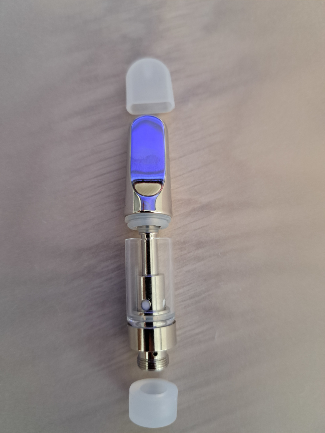 A glass bottle with a blue liquid inside, featuring the V4 - Metal Tip - 0.5ml.