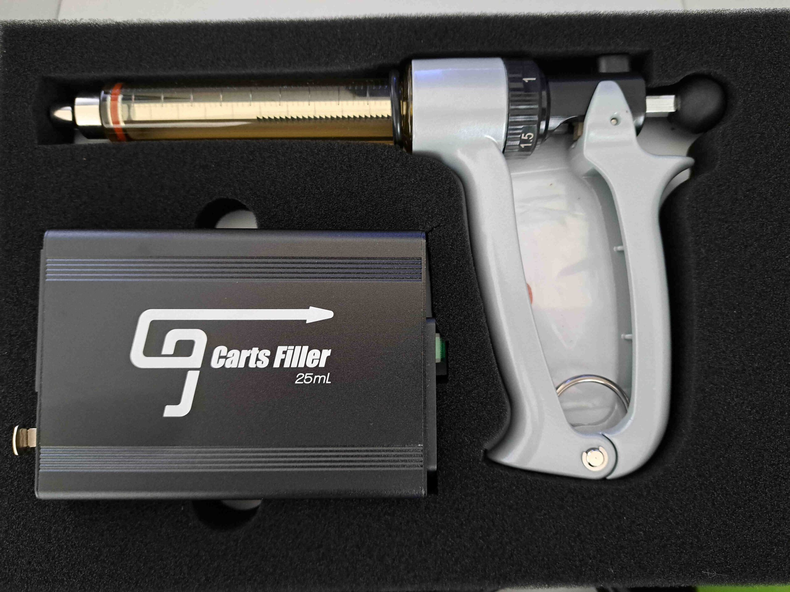 A grey gun is sitting in a box.